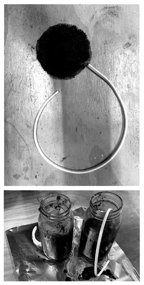1. The finished cathode 2. Two glass jars half filled with mud, with a wire from the cathode coming out of the opening