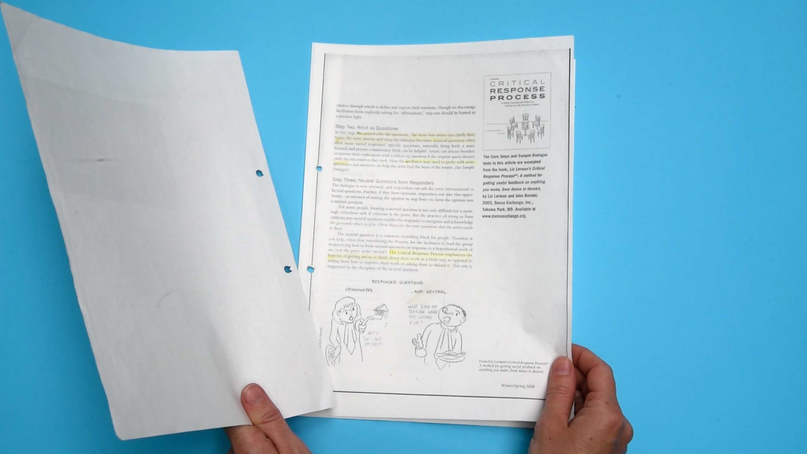 Still from a video, handling the a printed copy of the "Critical Response Process," Liz Lerman